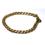 A VINTAGE 9CT GOLD CURB LINK BRACELET Having heavy gauge links. (approx 22cm)