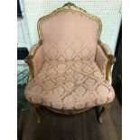 A PAIR OF EARLY 19TH CENTURY FRENCH GILTWOOD FRAMED ARMCHAIRS The shaped back rail centre with a