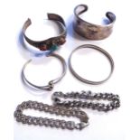 A COLLECTION OF 20TH CENTURY SILVER BANGLES AND BRACELETS Including a bangle set with coral and