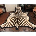 A ZEBRA SKIN RUG. (230cm x 104cm)