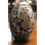 G. FIERAVINO, A LARGE 20TH CENTURY FLORAL DECORATED CHINA EGG. (48cm)