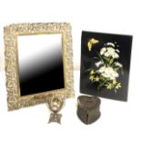 AN EARLY 20TH CENTURY WHITE METAL EASEL MIRROR Having a scrolled pierced border with bevelled