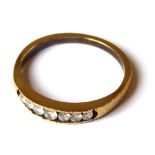 A YELLOW METAL AND DIAMOND HALF ETERNITY RING The single row of round cut diamonds (size P/Q).