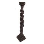 A 19TH CENTURY ITALIAN CARVED AND STAINED FRUITWOOD SINGLE CANDLE STICK The heavily carved barley
