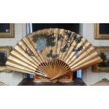 A LARGE 20TH CENTURY JAPANESE HAND PAINTED PAPER FAN Having a plain wooden frame and signed upper