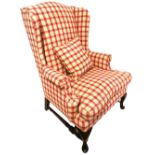 AN EARLY 20TH CENTURY WING ARMCHAIR In a check upholstery with loose cushions, on cabriole legs