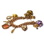 A LATE 19TH/EARLY 20TH CENTURY 9CT GOLD BRACELET Rope form bracelet set with ten yellow metal charms