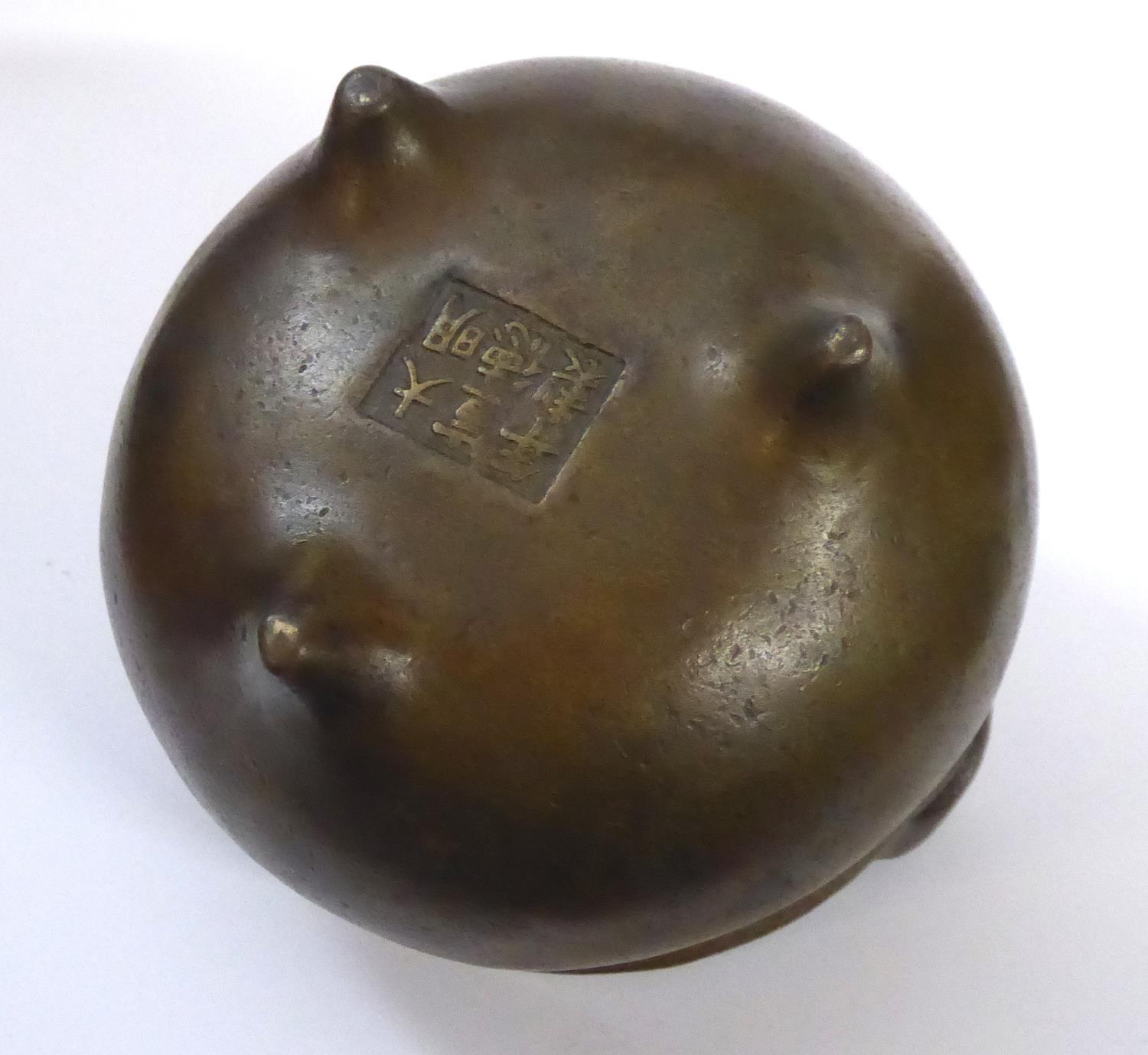 A CHINESE BRONZE CENSOR Spherical form on tripod feet. Bearing a six-character mark to base Approx - Image 7 of 9