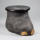 A LATE 19TH CENTURY TAXIDERMY ELEPHANT FOOT STOOL CONTAINER. (h 33cm x w 40cm x d 33cm)