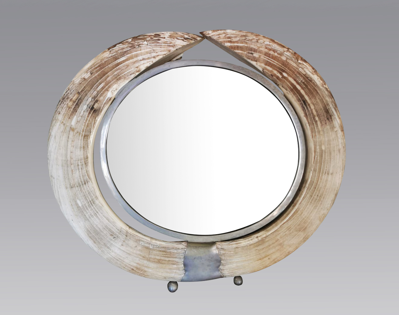 AN EARLY 20TH CENTURY HIPPO TUSK CIRCULAR DRESSING TABLE MIRROR. (diameter 52cm x 45cm)