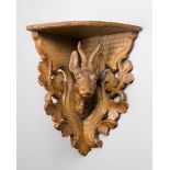 AN EARLY 20TH CENTURY BLACK FOREST CARVED FRUITWOOD BRACKET SHELF.