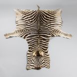 A 21ST CENTURY TAXIDERMY BURCHELL'S ZEBRA SKIN RUG. (l 280cm x w 165cm)