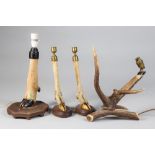 AN EARLY 20TH CENTURY TAXIDERMY GROUP, COMPRISING OF A PAIR OF BRASS MOUNTED DEER FOOT CANDLESTICKS,