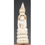 A 19TH CENTURY BURMESE CARVED IVORY BUDDHA SAT IN THE LOTUS POSITION WITH BEATIFIC EXPRESSION,