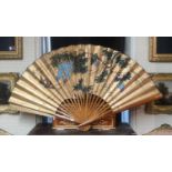 A LARGE 20TH CENTURY JAPANESE HAND PAINTED PAPER FAN Having a plain wooden frame and signed upper
