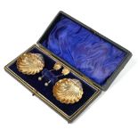 A CASED PAIR OF SILVER SHELL FORM SALTS With matching spoons, in fitted velvet lined box, hallmarked