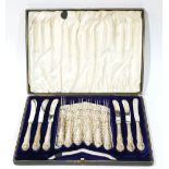 A CASED SET OF EDWARDIAN SILVER CAKE KNIVES AND FORKS In a fitted velvet lined box, hallmarked