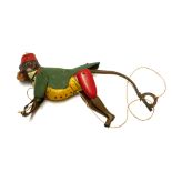 AN EARLY 20TH CENTURY GERMAN TINPLATE CLIMBING MONKEY TOY Wearing a red fez hat and green jacket. (
