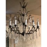 A LARGE VENETIAN DESIGN IRON TWELVE BRANCH CHANDELIER With three section glass centre , hung with