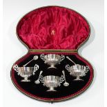 A CASED SET OF FOUR EDWARDIAN SILVER SALTS Having twin handles and half flute decoration,