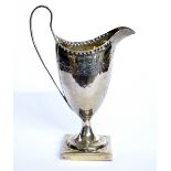 A GEORGIAN SILVER CLASSICAL HELMET FORM CREAM JUG With fine engraved decoration and square base,
