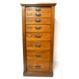 A LARGE 19TH CENTURY OAK WELLINGTON CHEST Of eight graduated drawers with gilt meal handles,