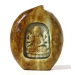 A CHINESE PEACH FORM SOAPSTONE CARVING Guanyin within a shrine. (approx 7cm x 8.5cm)