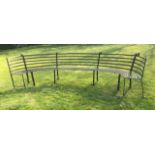 A LARGE LATE VICTORIAN/EDWARDIAN SEMI CIRCULAR WROUGHT IRON GARDEN BENCH