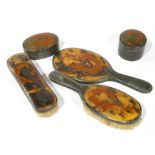 AN EARLY 20TH CENTURY CHINESE TORTOISESHELL DRESSING TABLE SET Comprising a hand mirror, two brushes