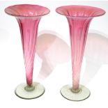 A PAIR OF VICTORIAN CRANBERRY AND VASELINE GLASS VASES Trumpet form with spiral flutes. (approx