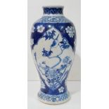 A 19TH CENTURY CHINESE BLUE AND WHITE PORCELAIN BALUSTER VASE With flowers and fauna, bearing a four