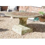AN 18TH/19TH CENTURY RED STONE GARDEN TABLE The 5cm thick circular top standing, on a faceted column