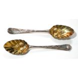A PAIR OF GEORGIAN SILVER BERRY SPOONS Having engraved armorial crest to finial and gilt embossed