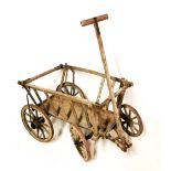 A 19TH CENTURY OAK AND ELM HAY/DOG CART With tapering slatted sides, on four iron bound spoked