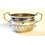A VICTORIAN SILVER PORRINGER Twin handles and half flute decoration, hallmarked Daniel and John