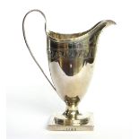 A GEORGIAN SILVER CLASSICAL HELMET FORM CREAM JUG With fine engraved decoration with lion crest,