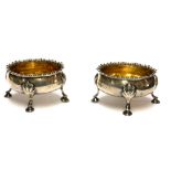 A PAIR OF GEORGIAN SILVER OVAL SALTS With gadrooned border, raised on four legs and gilt interior,
