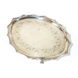A GEORGIAN SILVER OVAL TEAPOT STAND With scalloped edge and engraved border, raised on four lion paw