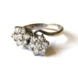 AN 18CT WHITE GOLD AND DIAMOND DOUBLE CLUSTER RING The arrangement of round cut stones forming two
