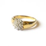 AN 18CT GOLD AND DIAMOND DAISY CLUSTER RING Having an arrangement of diamonds in a plain gold