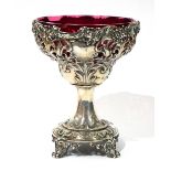 A VICTORIAN SILVER AND CRANBERRY GLASS SWEETMEAT TAZZA Having pierced as scrolled decoration and