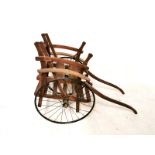 AN EARLY 20TH CENTURY BEECHWOOD TRAP/DOG CART On two iron spoked wheels. (128cm x 52cm)