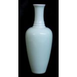 A CHINESE CELADON GLAZE BOTTLE VASE Having three consecutive rings to neck and Kangxi six-characte