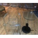 A DESIGNER GLASS TABLE Along with Philip Stark Perspex chair. (40cm x 50cm x 72cm)