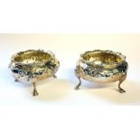 A PAIR OF VICTORIAN SILVER SALTS Spherical form with embossed decoration and tripod feet, hallmarked