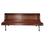 A TENNIS COURT/GARDEN BENCH With teak slats on wrought iron supports. (200cm x 70cm x 76cm)