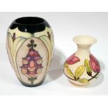 MOORCROFT, TWO 20TH CENTURY POTTERY VASES One lilac floral with tube lined decoration, marked 'WM'