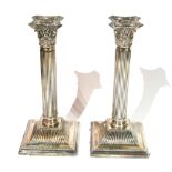 A PAIR OF EDWARDIAN SILVER CANDLESTICKS Classical firm with reeded columns, hallmarked 'J.