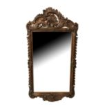 A 19TH CENTURY ITALIAN CARVED PINE FRAMED MIRROR With pierced cartouche above a silvered plate. (