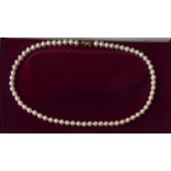 WITHDRAWN A 9CT GOLD AND PEARL NECKLACE The single strand of cultured pearls with a bow form gold